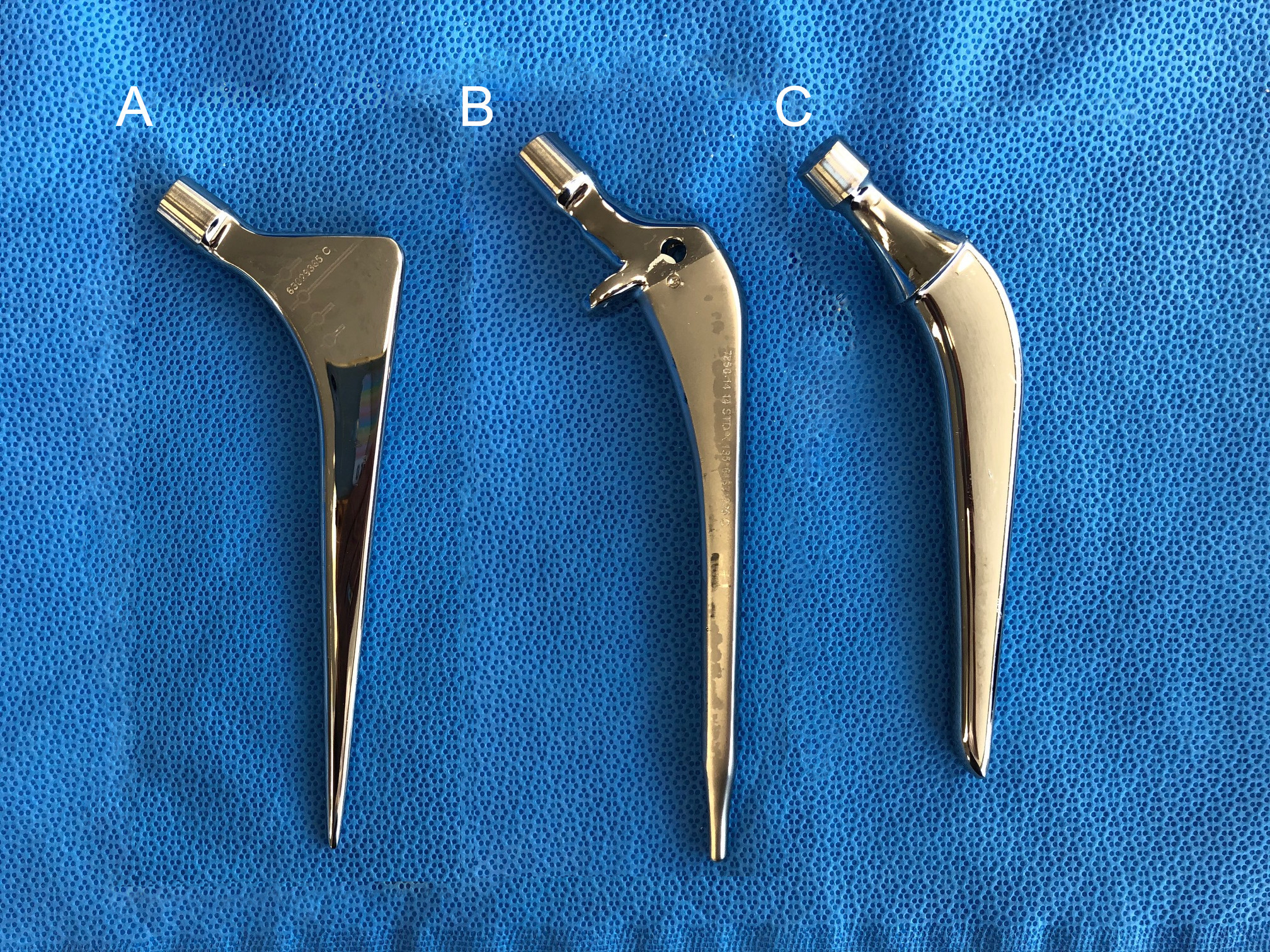 Fig. 1 
            a) The collarless polished tapered stem (Zimmer Biomet, USA), b) Versys Advocate (Zimmer Biomet), and c) Charnley-Marcel-Kerboull stem (Zimmer Biomet).
          